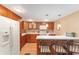 Modern kitchen with wood cabinets and white countertops at 807 Maple Ln, The Villages, FL 32159