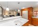 Kitchen with double sink and view of living room at 807 Maple Ln, The Villages, FL 32159