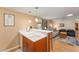 Kitchen with double sink and view into living area at 807 Maple Ln, The Villages, FL 32159