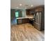 Modern kitchen featuring dark brown cabinets, stainless steel appliances, and a large island at 827 E Clifford Ave, Eustis, FL 32726