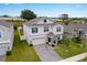 Two-story house with a paver driveway and manicured lawn at 848 Carmillion Ct, Groveland, FL 34736