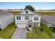 Two-story house with a paver driveway and landscaped yard at 848 Carmillion Ct, Groveland, FL 34736