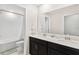 Bathroom with a double vanity and a view of the shower and toilet at 848 Carmillion Ct, Groveland, FL 34736