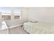 Simple bedroom with a twin-size bed and two windows at 848 Carmillion Ct, Groveland, FL 34736