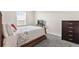 Sleigh bed in bedroom with patterned bedding and dark dresser at 848 Carmillion Ct, Groveland, FL 34736