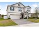 Two-story house with a stone accent and a two-car garage at 848 Carmillion Ct, Groveland, FL 34736