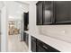 Kitchen with dark cabinets and white countertops, offering ample storage at 848 Carmillion Ct, Groveland, FL 34736