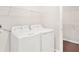 Laundry room with washer, dryer, and shelving at 848 Carmillion Ct, Groveland, FL 34736