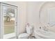 Clean powder room with white sink, toilet and door leading to the backyard at 848 Carmillion Ct, Groveland, FL 34736