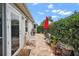 Outdoor patio with seating, adjacent to house and greenery at 848 Folsum Pl, The Villages, FL 32162