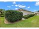 Landscaped yard with lush hedges and lawn at 848 Folsum Pl, The Villages, FL 32162