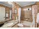 Bathroom with floral wallpaper,granite countertop and bathtub at 848 Folsum Pl, The Villages, FL 32162