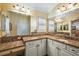 Bathroom with granite countertops, double sinks, and white cabinets at 848 Folsum Pl, The Villages, FL 32162