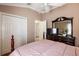 Bedroom with a comfortable bed and built-in dresser at 848 Folsum Pl, The Villages, FL 32162