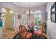 Bright breakfast nook features a glass table and four chairs, and blue patterned wallpaper at 848 Folsum Pl, The Villages, FL 32162