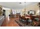 Formal dining area with a large table, chandelier, and hardwood floors at 848 Folsum Pl, The Villages, FL 32162