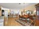 Spacious dining area with hardwood floors and decorative chandelier at 848 Folsum Pl, The Villages, FL 32162