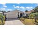 One-story home with attached garage and landscaped yard at 848 Folsum Pl, The Villages, FL 32162