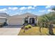 One-story home with attached garage and landscaped yard at 848 Folsum Pl, The Villages, FL 32162