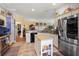 Modern kitchen with island, stainless steel appliances, and granite countertops at 848 Folsum Pl, The Villages, FL 32162