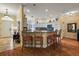 Kitchen with breakfast bar, granite countertops, and white cabinetry at 848 Folsum Pl, The Villages, FL 32162