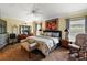 Main bedroom with king-size bed, hardwood floors, and ceiling fan at 848 Folsum Pl, The Villages, FL 32162