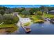 Aerial view of lakefront property with sandy beach at 9605 Hollyglen Pl, Windermere, FL 34786