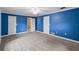 Bedroom with blue walls, carpet, and ceiling fan at 9605 Hollyglen Pl, Windermere, FL 34786