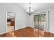 Dining room with hardwood floors, access to kitchen and backyard at 9605 Hollyglen Pl, Windermere, FL 34786