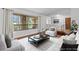 Virtually staged living room with hardwood floors and large windows at 9605 Hollyglen Pl, Windermere, FL 34786