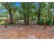 Wooden swing set in a shaded playground area at 9605 Hollyglen Pl, Windermere, FL 34786