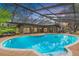 Relaxing kidney-shaped pool with a screened enclosure at 9605 Hollyglen Pl, Windermere, FL 34786