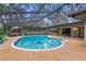 Refreshing kidney-shaped pool with screened patio at 9605 Hollyglen Pl, Windermere, FL 34786