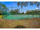 Two tennis courts surrounded by chain link fence at 9605 Hollyglen Pl, Windermere, FL 34786