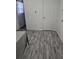 Neutral bedroom with closet, laminate floor, and window with patterned curtain at 10094 Sw 153Rd Ln, Dunnellon, FL 34432