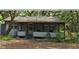 Quaint cottage-style home with a covered front porch, offering a relaxing outdoor space at 10094 Sw 153Rd Ln, Dunnellon, FL 34432
