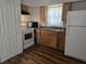 Functional kitchen featuring updated cabinets, appliances, and laminate floor at 10094 Sw 153Rd Ln, Dunnellon, FL 34432