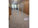 Cozy living room featuring wood paneling, carpet, and abundant natural light at 10094 Sw 153Rd Ln, Dunnellon, FL 34432