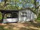 Cozy home featuring a covered porch and a side door, nestled amongst beautiful trees at 10094 Sw 153Rd Ln, Dunnellon, FL 34432
