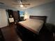 Spacious bedroom with a king-size bed and dark wood furniture at 1017 Willow Dr, Leesburg, FL 34748