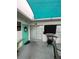 Inviting condo exterior, featuring a teal door and shaded patio at 1017 Willow Dr, Leesburg, FL 34748