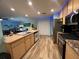 Modern kitchen with stainless steel appliances and light wood cabinets at 1017 Willow Dr, Leesburg, FL 34748