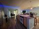 Island kitchen with stainless steel appliances and light wood cabinets at 1017 Willow Dr, Leesburg, FL 34748