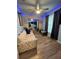 Comfortable living room with a floral sofa and ceiling fan at 1017 Willow Dr, Leesburg, FL 34748