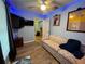 Cozy living room with a floral sofa and plenty of natural light at 1017 Willow Dr, Leesburg, FL 34748