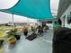Screened patio with shade sail, seating, and grill at 1017 Willow Dr, Leesburg, FL 34748