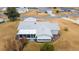 Aerial view of home showcasing its roofline and screened porch at 10476 Se 178Th St, Summerfield, FL 34491