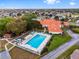 Aerial view of community pool, clubhouse, and surrounding landscape at 10476 Se 178Th St, Summerfield, FL 34491