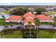 Community clubhouse with Spanish tile roof and lush landscaping at 10476 Se 178Th St, Summerfield, FL 34491