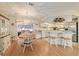 Dining room with a round wooden table, white chairs, and a view to the kitchen at 10476 Se 178Th St, Summerfield, FL 34491